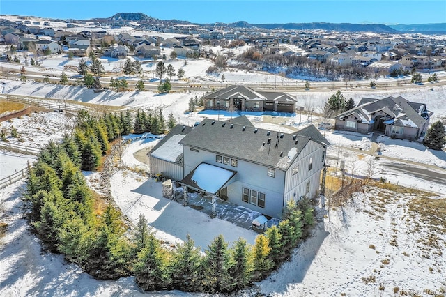 snowy aerial view with a mountain view