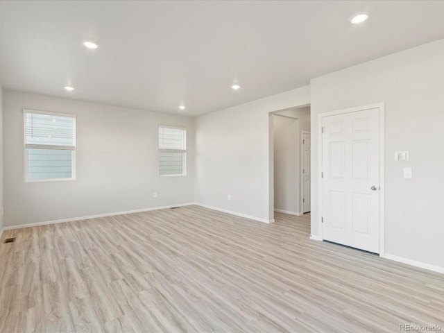 spare room with a healthy amount of sunlight, light wood finished floors, and recessed lighting