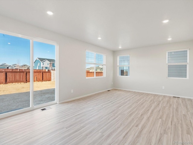 empty room with recessed lighting and light wood finished floors