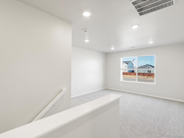 unfurnished room featuring baseboards, visible vents, carpet flooring, and recessed lighting