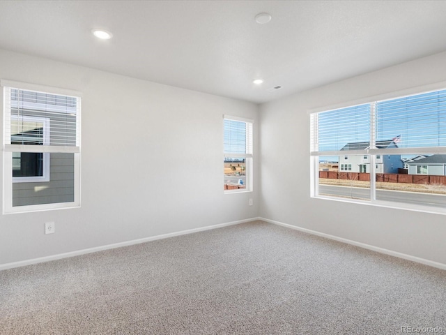 carpeted empty room with recessed lighting and baseboards