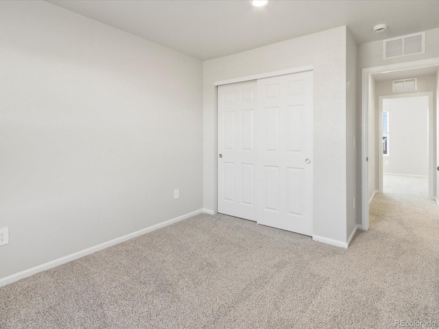 unfurnished bedroom featuring carpet floors, baseboards, and visible vents