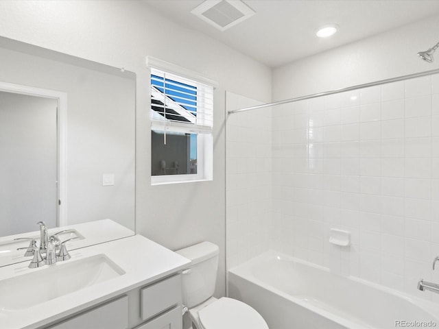 bathroom with visible vents, bathing tub / shower combination, toilet, and vanity