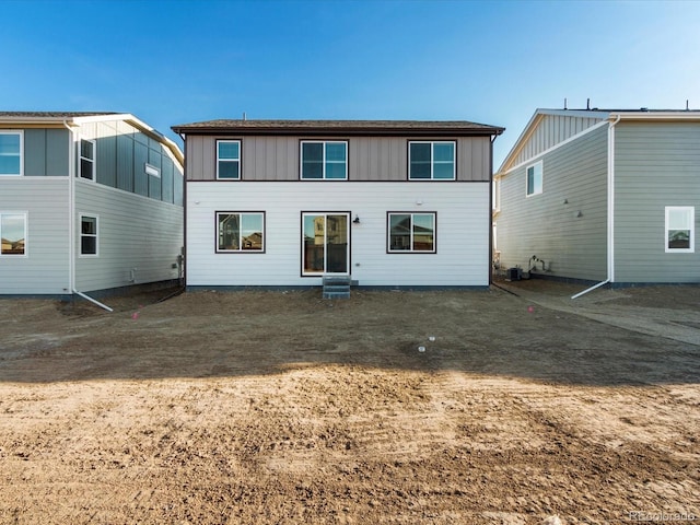 rear view of property with board and batten siding