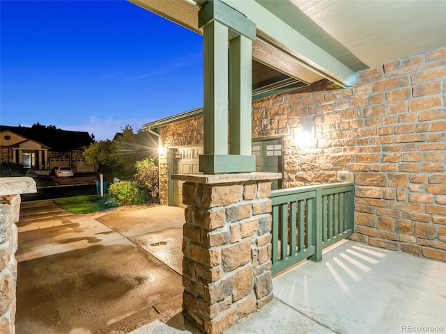 patio terrace at dusk featuring a porch