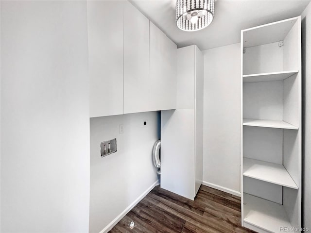 clothes washing area with baseboards, cabinet space, dark wood-style flooring, and electric dryer hookup