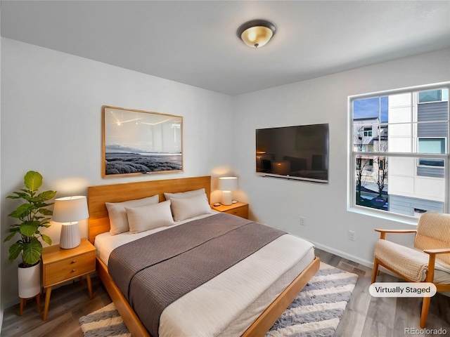 bedroom featuring wood finished floors and baseboards