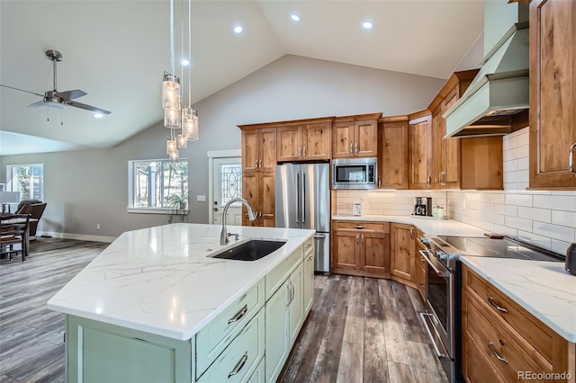 kitchen with a sink, premium range hood, a center island with sink, appliances with stainless steel finishes, and dark wood-style flooring