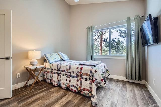 bedroom featuring baseboards and wood finished floors