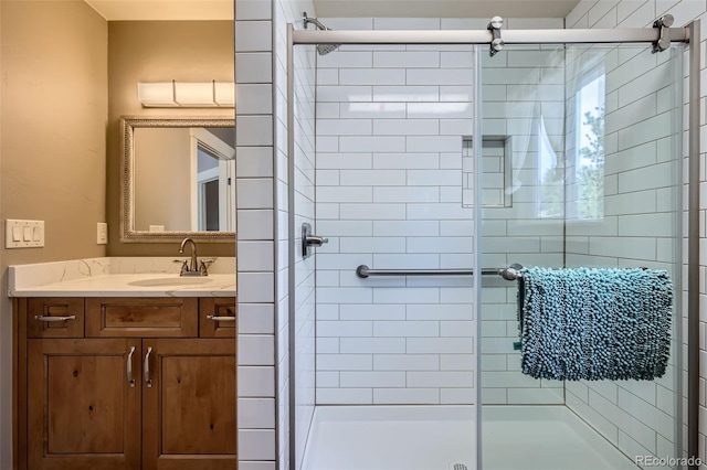 full bathroom with a shower stall and vanity