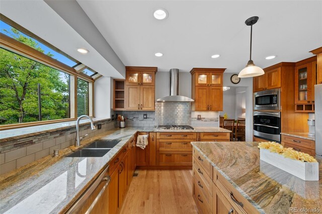 18 Blue Sage, Littleton, CO 80127 - kitchen with appliances with stainless steel finishes, wall chimney range hood, light stone counters, backsplash, and recessed lighting