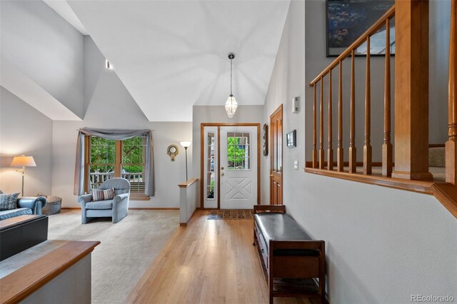 18 Blue Sage, Littleton, CO 80127 - entrance foyer featuring stairway, high vaulted ceiling, and wood finished floors