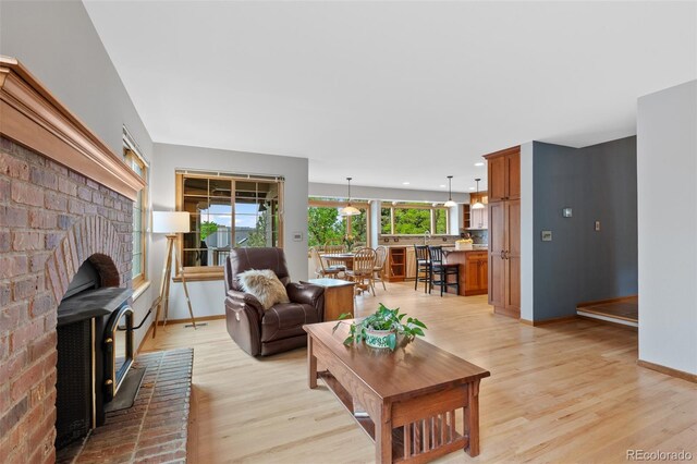 18 Blue Sage, Littleton, CO 80127 - living area with light wood finished floors and a wood stove