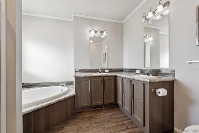 bathroom featuring crown molding, vanity, and a bathing tub