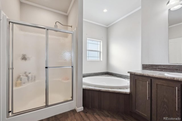 bathroom featuring ornamental molding, hardwood / wood-style floors, plus walk in shower, and vanity