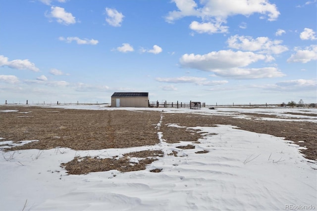 yard layered in snow with a rural view