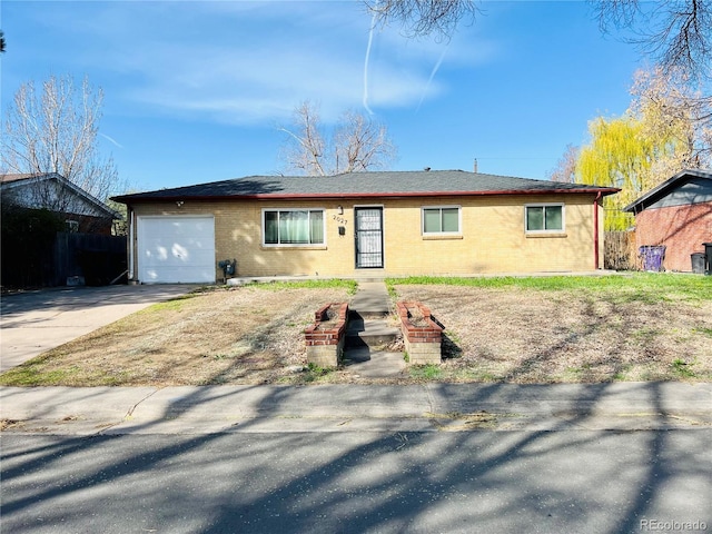 2027 S Newton St, Denver, CO 80219 - ranch-style home featuring a garage, brick siding, driveway, and fence