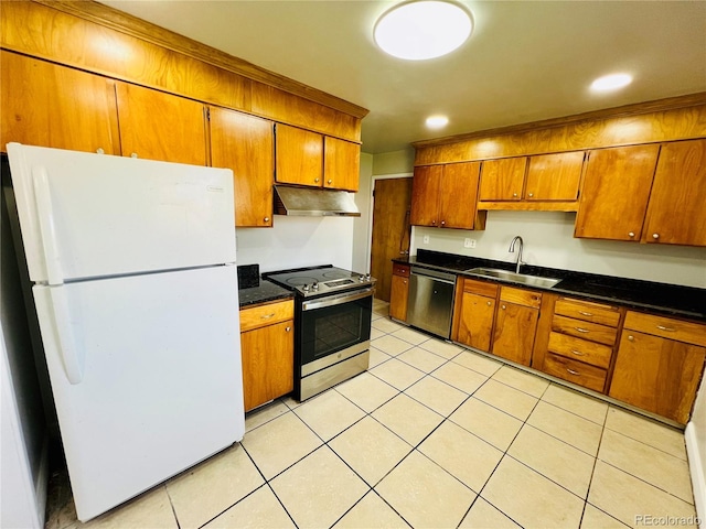 2027 S Newton St, Denver, CO 80219 - kitchen featuring under cabinet range hood, brown cabinets, a sink, and appliances with stainless steel finishes