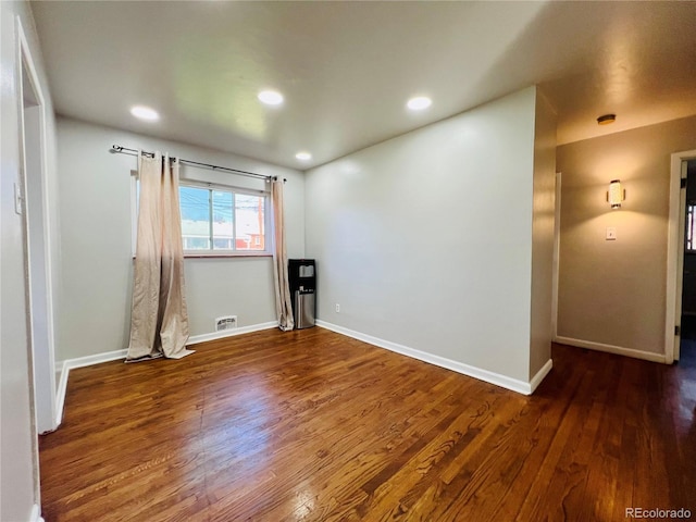 2027 S Newton St, Denver, CO 80219 - spare room with wood finished floors, baseboards, and visible vents