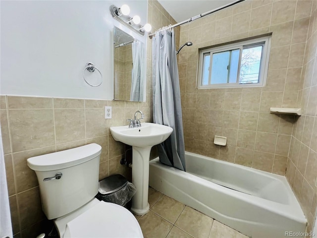 2027 S Newton St, Denver, CO 80219 - bathroom with tile patterned floors, shower / bath combination with curtain, tile walls, and toilet
