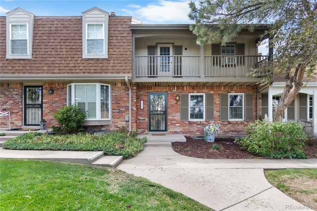 7355 S Knolls Way, Centennial, CO 80122 - view of front facade featuring a balcony, brick siding, and a shingled roof