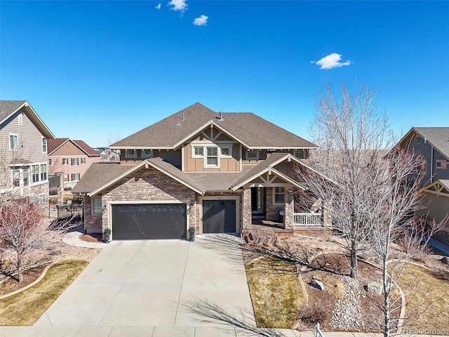 craftsman house featuring concrete driveway, covered porch, an attached garage, board and batten siding, and stone siding