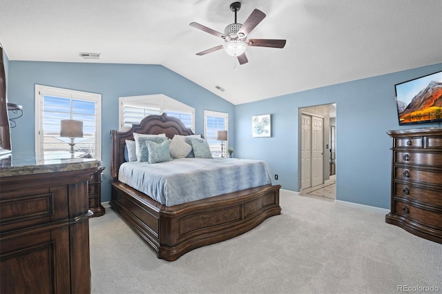 bedroom with multiple windows, visible vents, vaulted ceiling, and light colored carpet