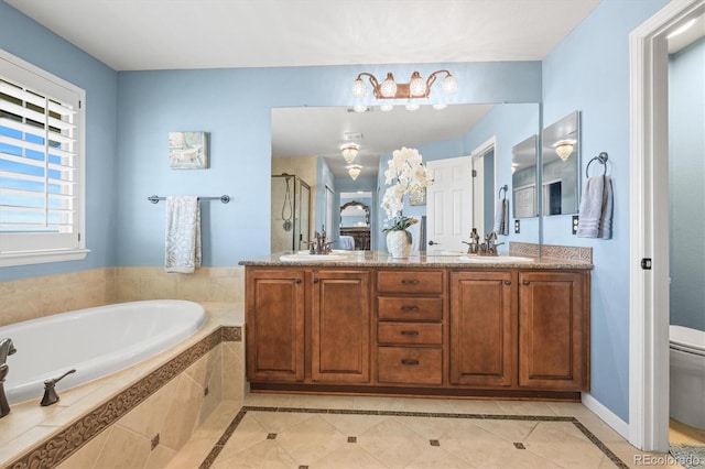 full bath with double vanity, toilet, a stall shower, a bath, and tile patterned floors