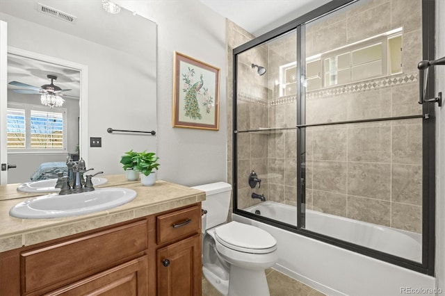 bathroom with enclosed tub / shower combo, ceiling fan, toilet, vanity, and visible vents