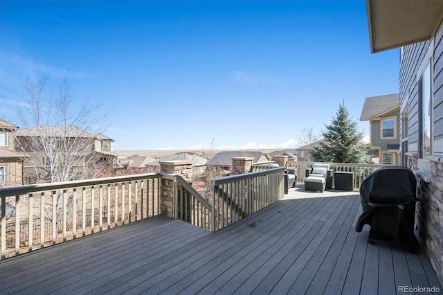 wooden deck featuring a residential view and grilling area