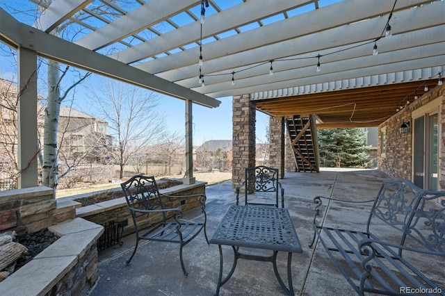 view of patio / terrace featuring stairs, outdoor dining area, and a pergola