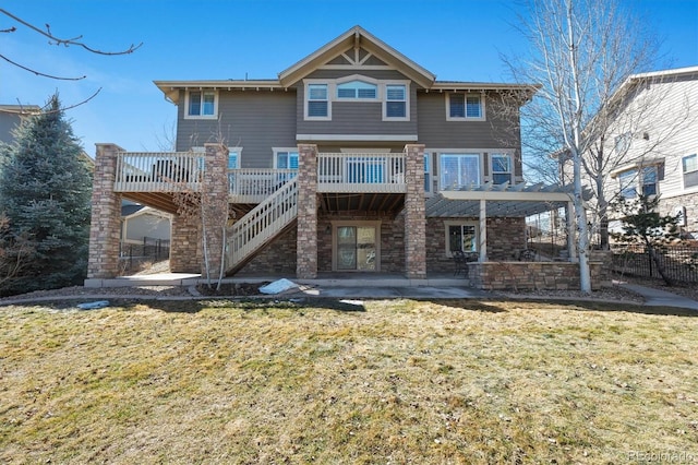 back of property featuring a yard, a patio, and stairway