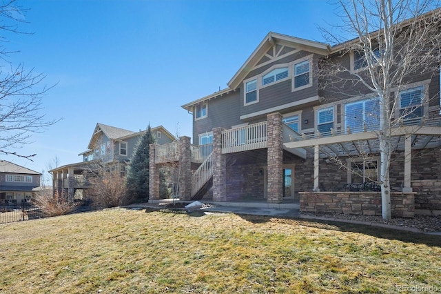 back of property featuring stairway, a patio, and a yard