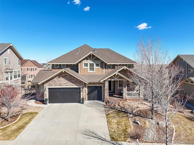 craftsman house with a porch, driveway, stone siding, a shingled roof, and a garage