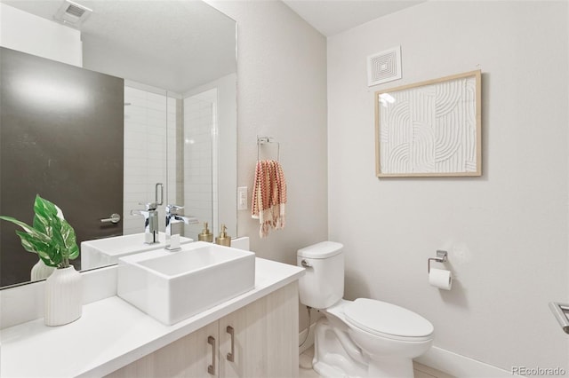 1836 Grove St Unit 108, Denver, CO 80204 - bathroom with toilet, vanity, baseboards, and tile patterned flooring