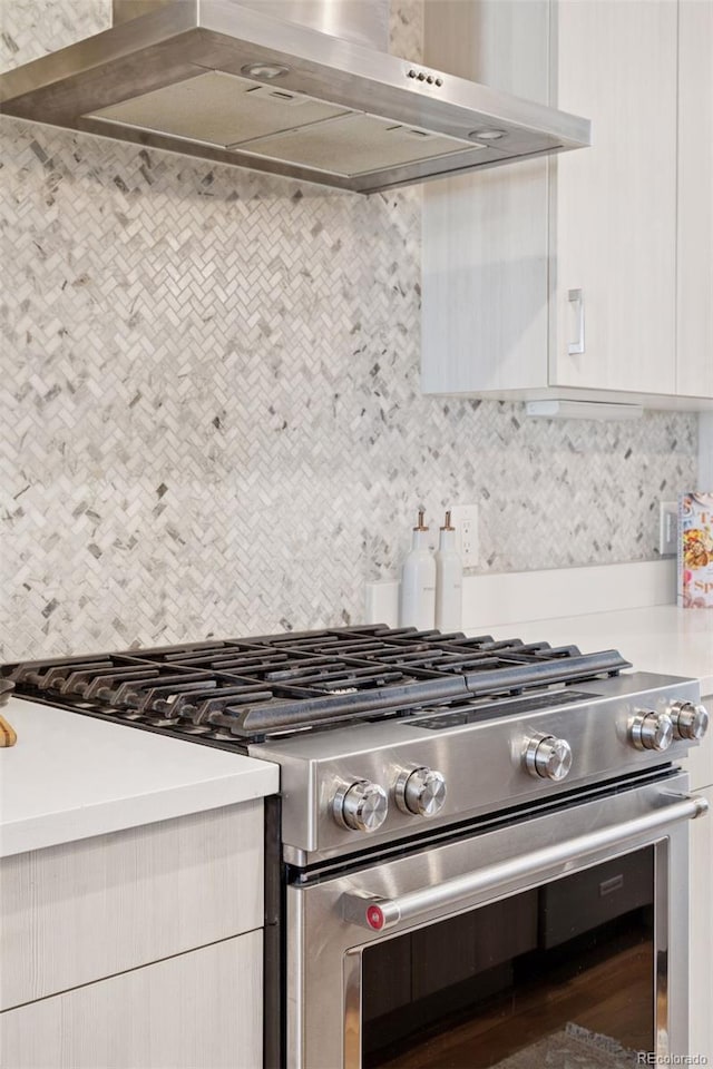 1836 Grove St Unit 108, Denver, CO 80204 - kitchen with stainless steel gas range oven, wall chimney exhaust hood, backsplash, light countertops, and modern cabinets