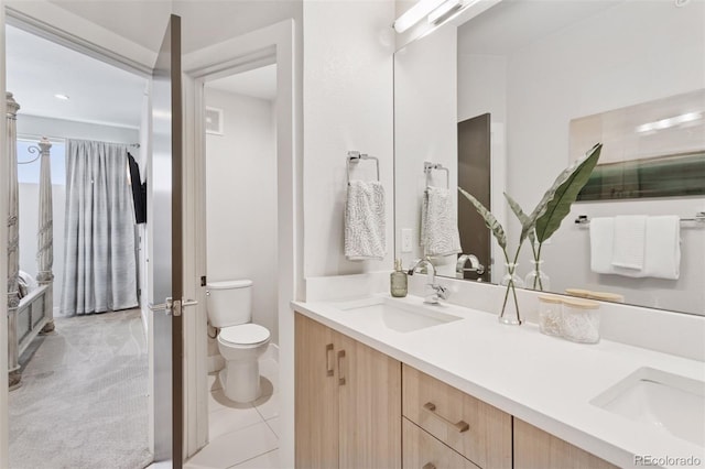 1836 Grove St Unit 108, Denver, CO 80204 - full bathroom with double vanity, toilet, and tile patterned floors