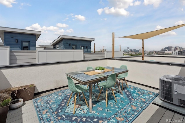 1836 Grove St Unit 108, Denver, CO 80204 - wooden terrace with central AC unit, outdoor dining area, and a view of city