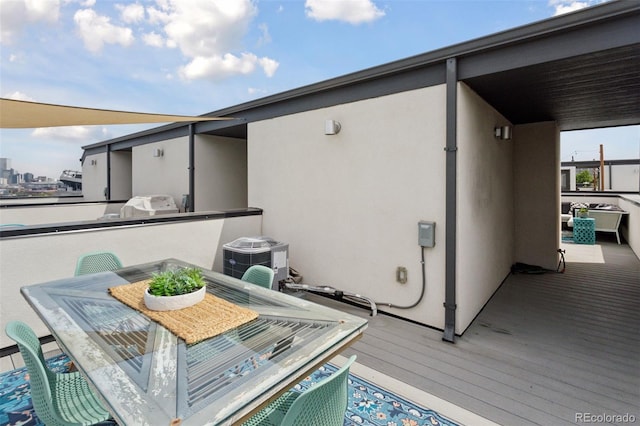 1836 Grove St Unit 108, Denver, CO 80204 - wooden deck featuring central AC and outdoor dining space