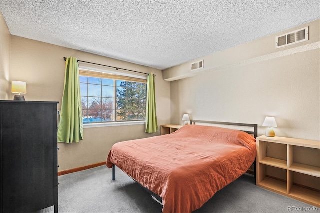 bedroom featuring carpet flooring and a textured ceiling