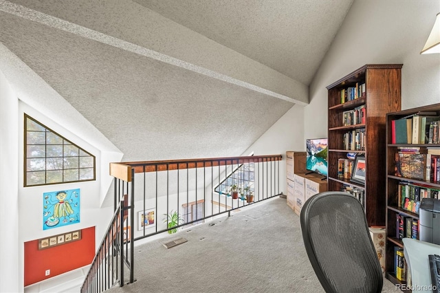 carpeted office featuring lofted ceiling, a textured ceiling, and plenty of natural light