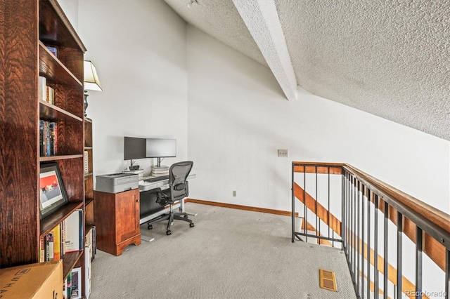 carpeted office with vaulted ceiling and a textured ceiling