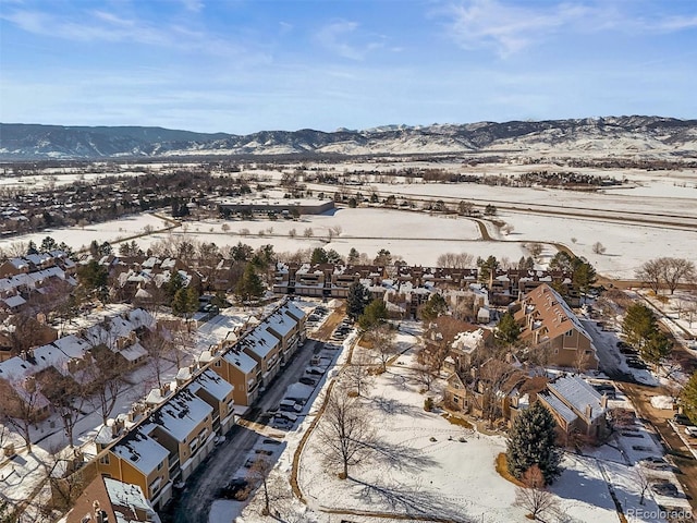 snowy aerial view featuring a mountain view