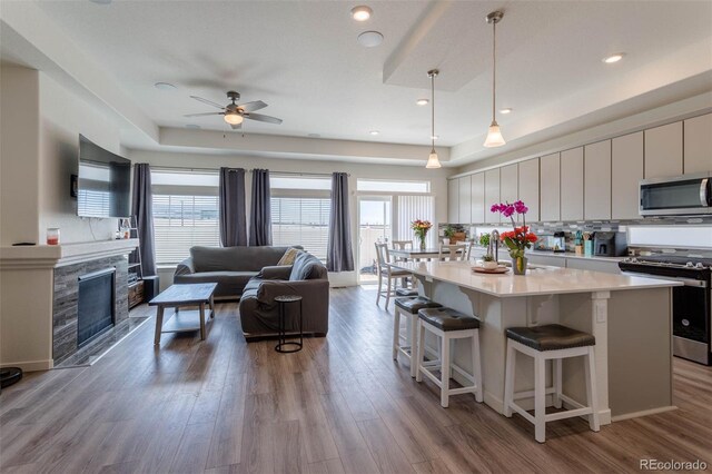 kitchen featuring plenty of natural light, hardwood / wood-style flooring, a kitchen island, and appliances with stainless steel finishes