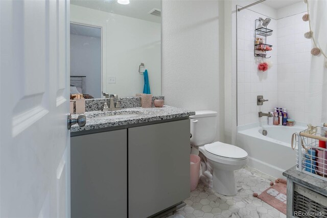 full bathroom with tiled shower / bath combo, tile flooring, toilet, and vanity