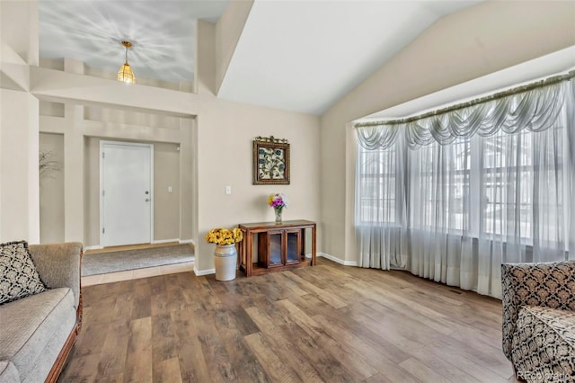 16048 Butterwort Cir, Parker, CO 80134 - living room featuring lofted ceiling, wood finished floors, and baseboards