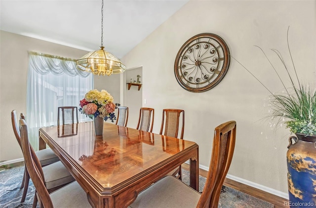 16048 Butterwort Cir, Parker, CO 80134 - dining space with vaulted ceiling, wood finished floors, a chandelier, and baseboards