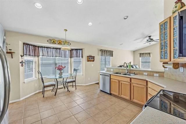 16048 Butterwort Cir, Parker, CO 80134 - kitchen featuring light countertops, light tile patterned floors, a sink, a peninsula, and appliances with stainless steel finishes