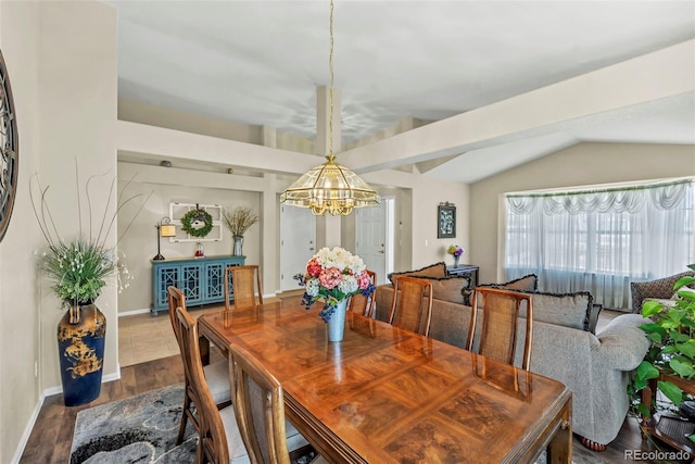 16048 Butterwort Cir, Parker, CO 80134 - dining area featuring vaulted ceiling, baseboards, a notable chandelier, and dark wood finished floors