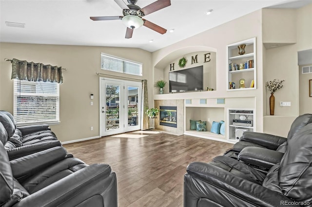 16048 Butterwort Cir, Parker, CO 80134 - living area featuring wood finished floors, visible vents, baseboards, built in shelves, and ceiling fan